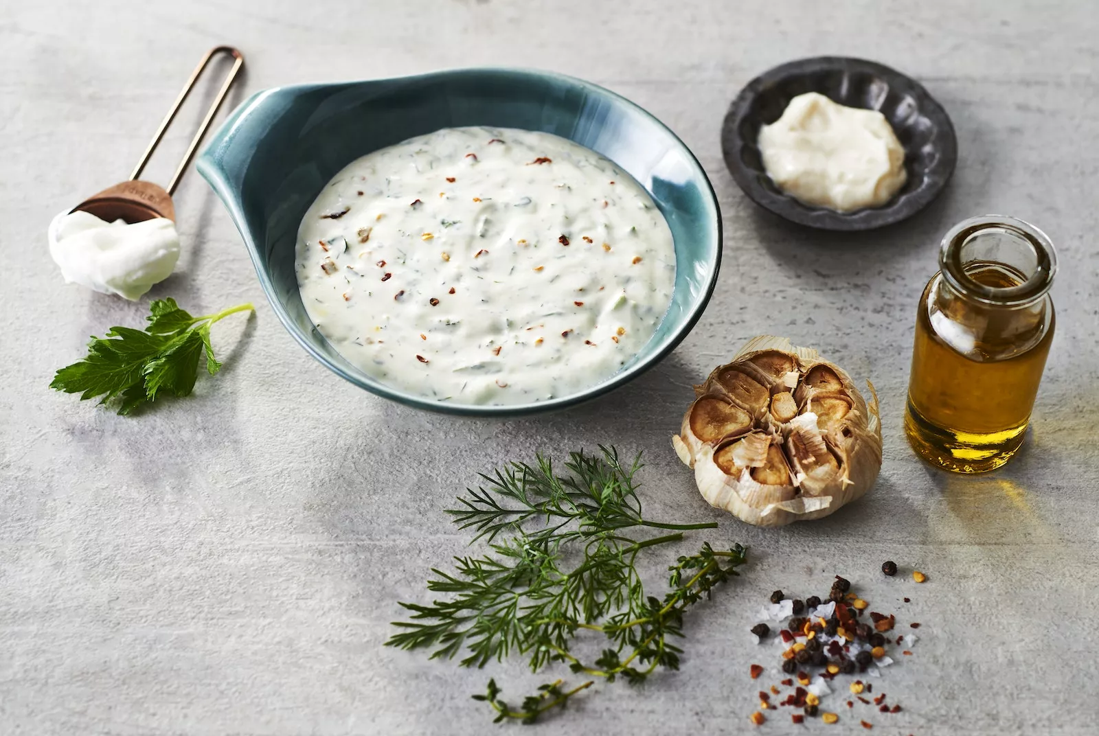 Smashed Potatoes with Herby Aioli Dip_The Food Group_Web Res 1 A little dish of herby aioli with roasted garlic, oil, and other accoutrements nearby. We call these ingredient cues in the biz.