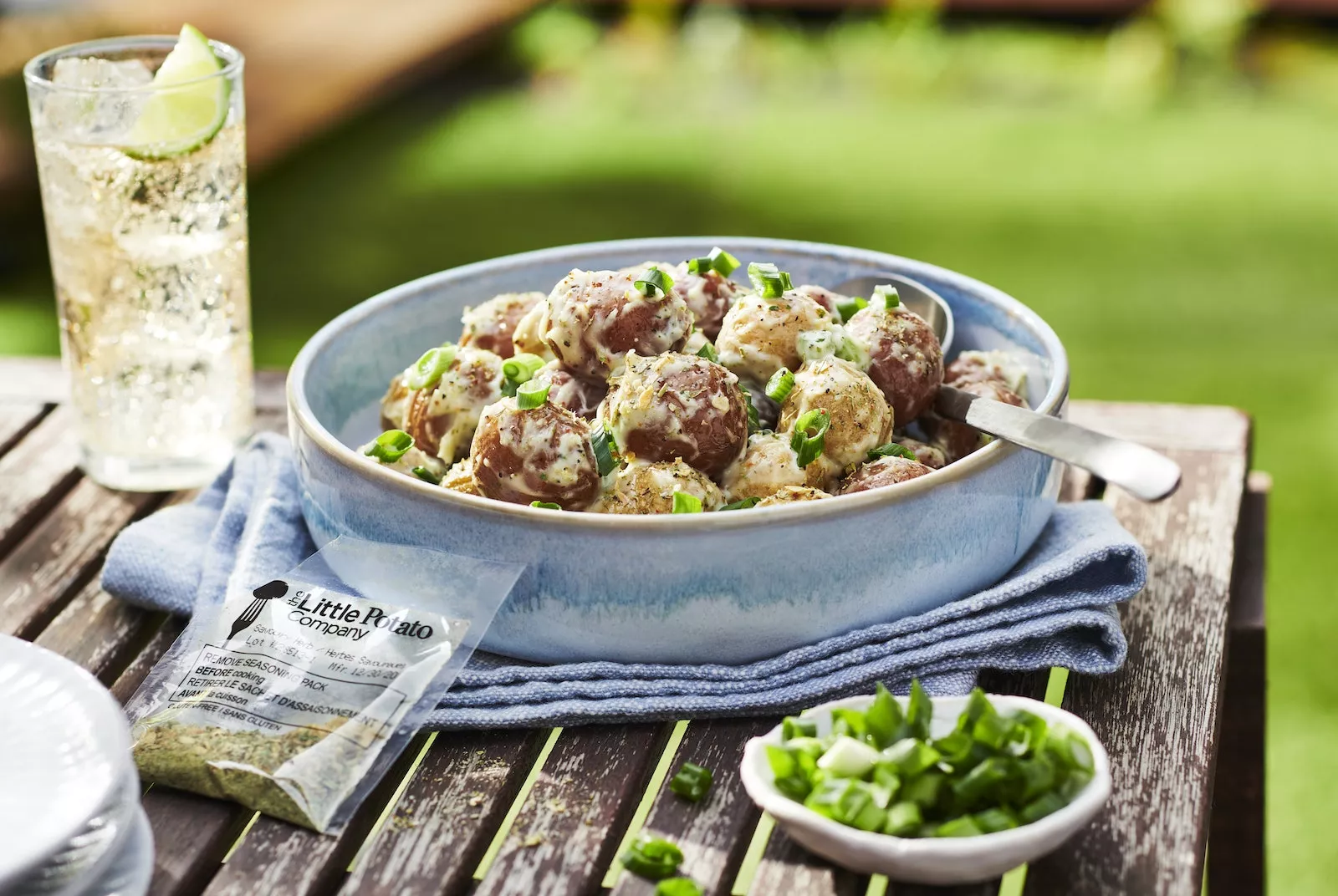 Easy As 1-2-3 Potato Salad_The Food Group_High Res 2 An easy to make potato salad in a blue bowl with a refreshing drink nearby.