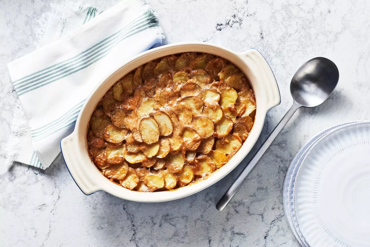 Basic-Scalloped-Potatoes_The-Food-Group_High-Res-1 A casserole dish of basic scalloped potatoes.