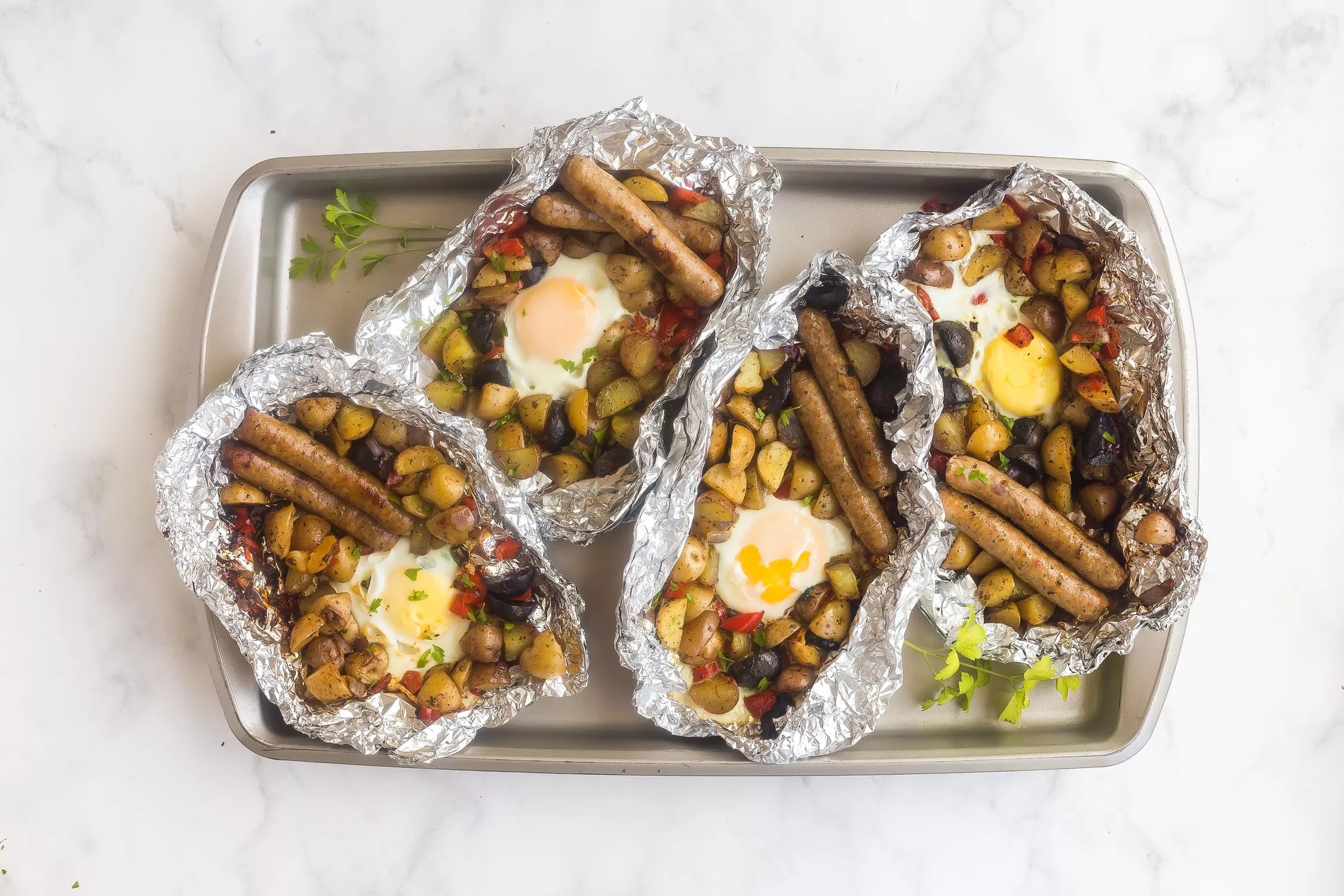 A baking sheet of the most delicious camping breakfast you could ever hope to have. Sausages, potatoes, peppers. Yum.