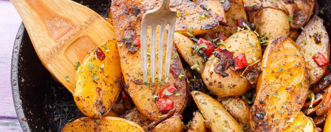 A cast iron skillet of breakfast home fries.