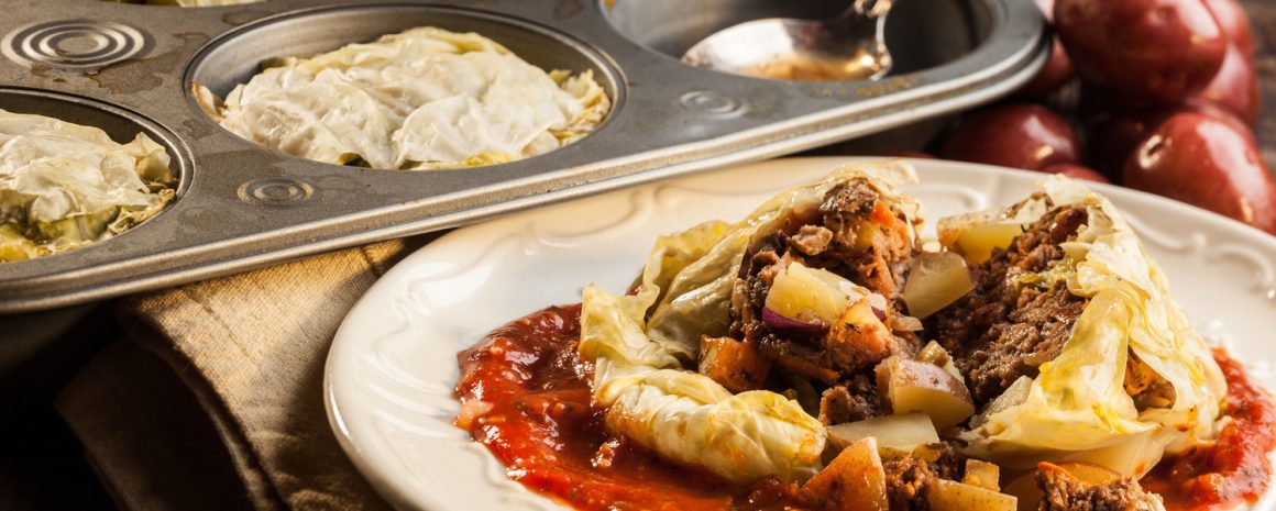 A plate of cabbage rolls made in a muffin tin.