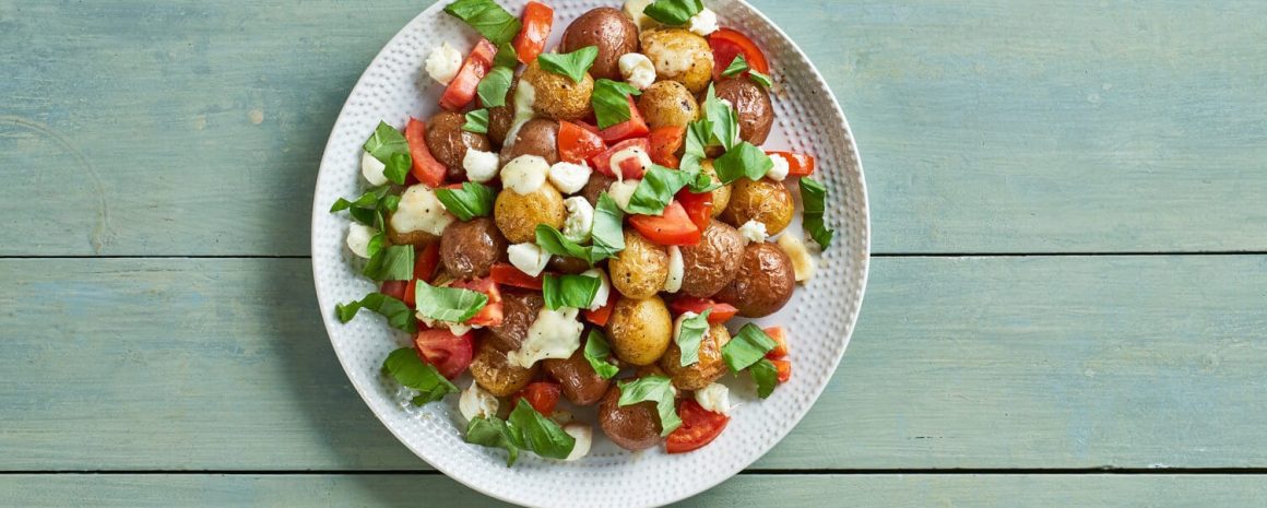 A beautiful colorful bowl of caprese roasted little potatoes.