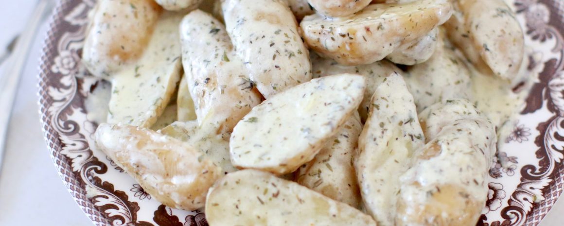 Fingerling potatoes covered in a creamy sauce.