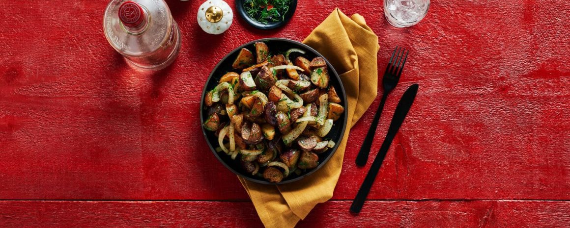 A bowl of dill and parsley pan-fried potatoes.