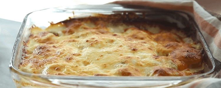 A glass dish of scalloped potatoes.