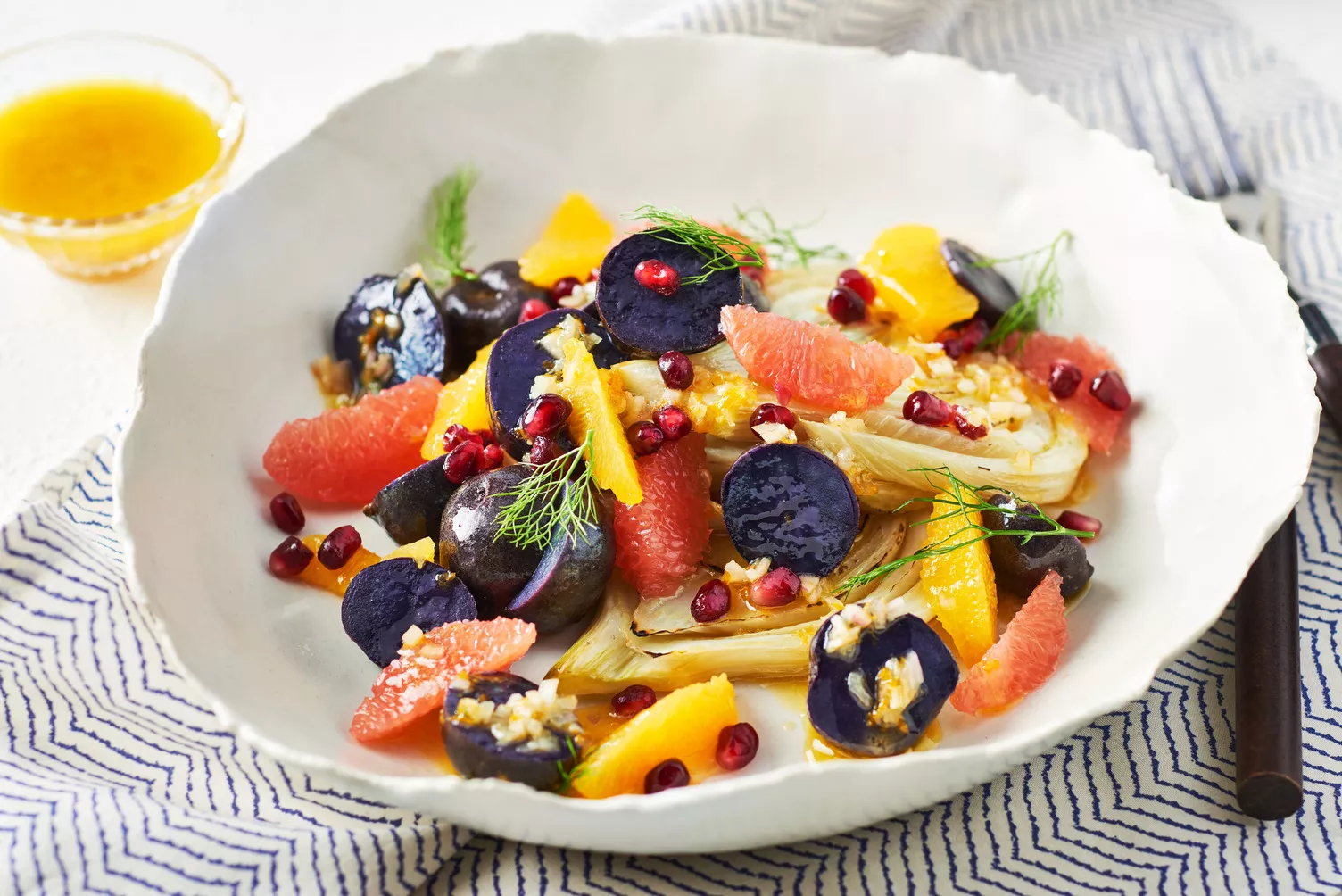 Fennel-and-Potato-Salad-with-Orange-Vinaigrette_The-Food-Group_Web-Res-2 A bowl of little potatoes with fennel and colourful fruits and veggies.