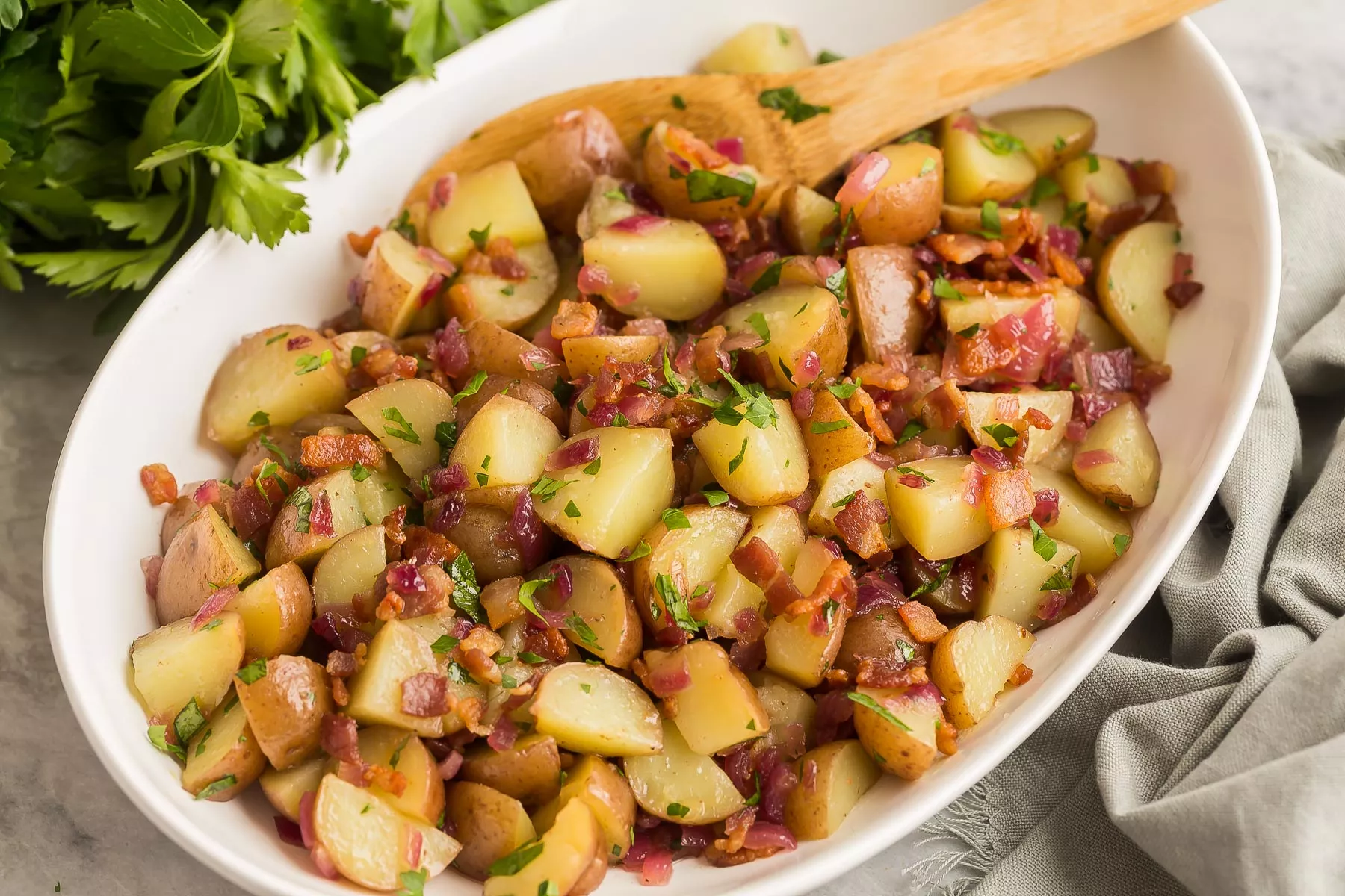 A nice big bowl of German potato salad with lots of bacon bits.