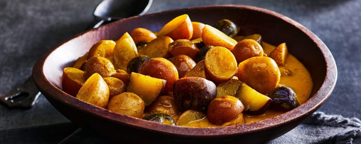 Golden milk poached potatoes in a nice wooden bowl.