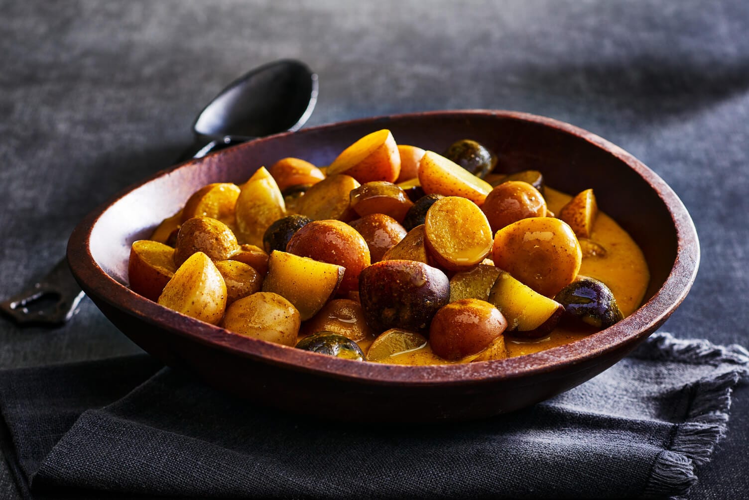 Golden milk poached potatoes in a nice wooden bowl.