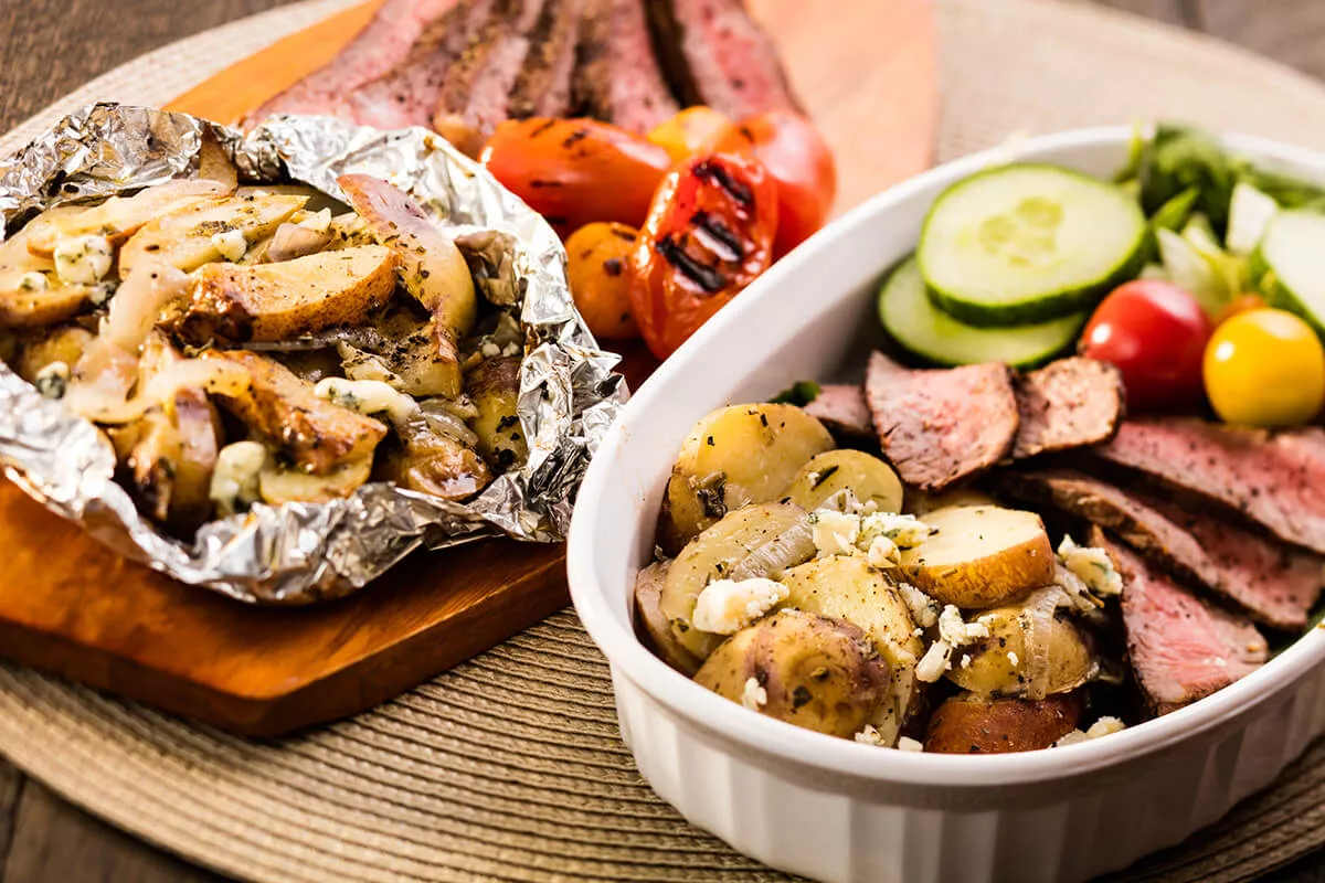 Serving bowl with foil and veggies inside.