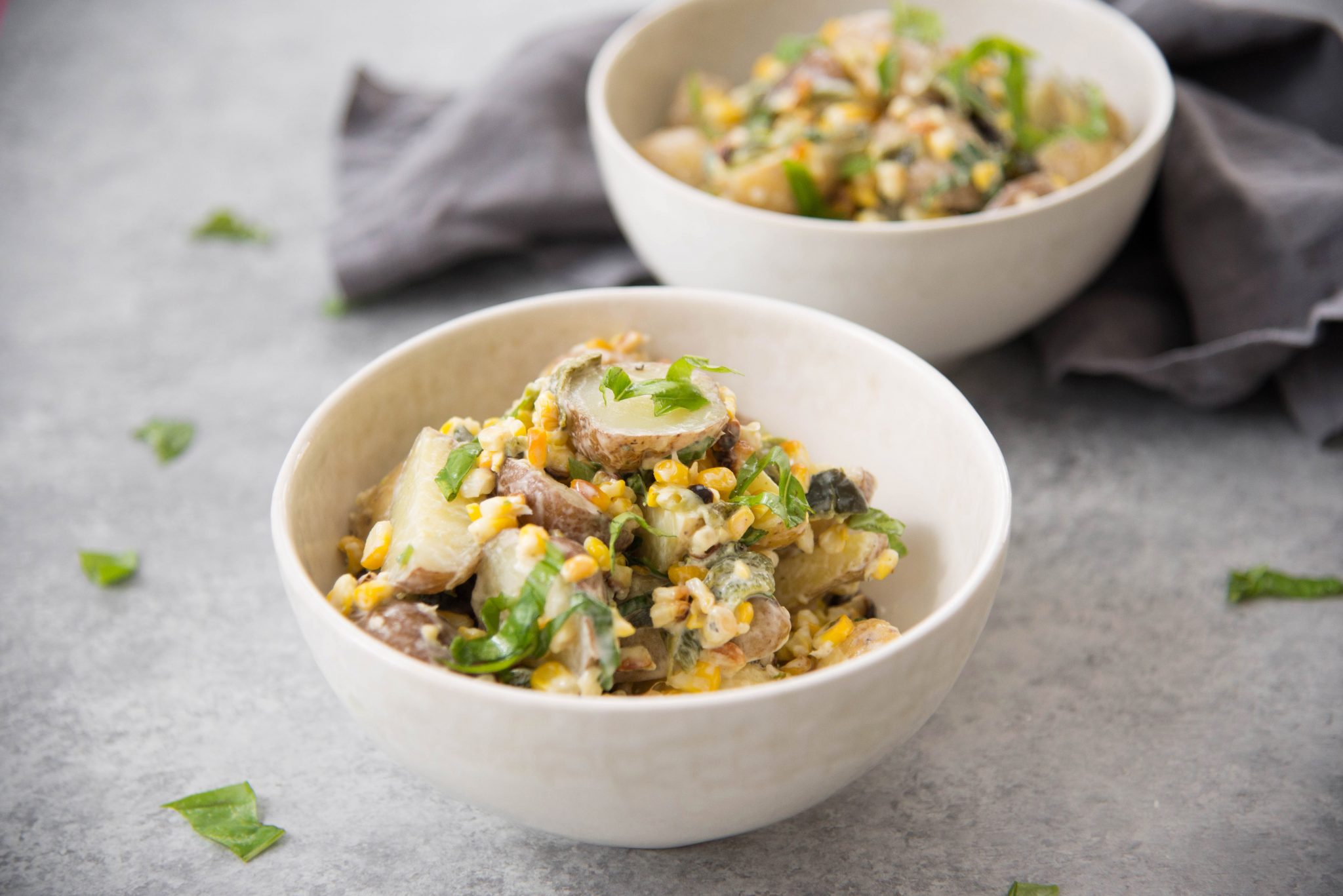 Bowls of grilled corn and poblano potato salads.