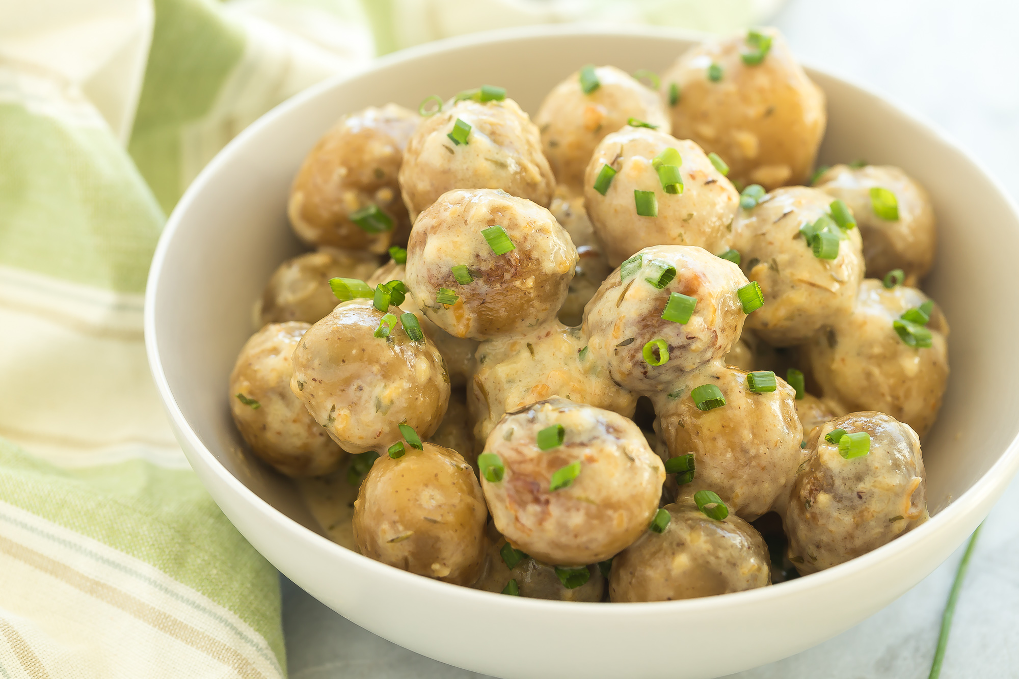 A bowl of slow cooker cheesy potatoes.