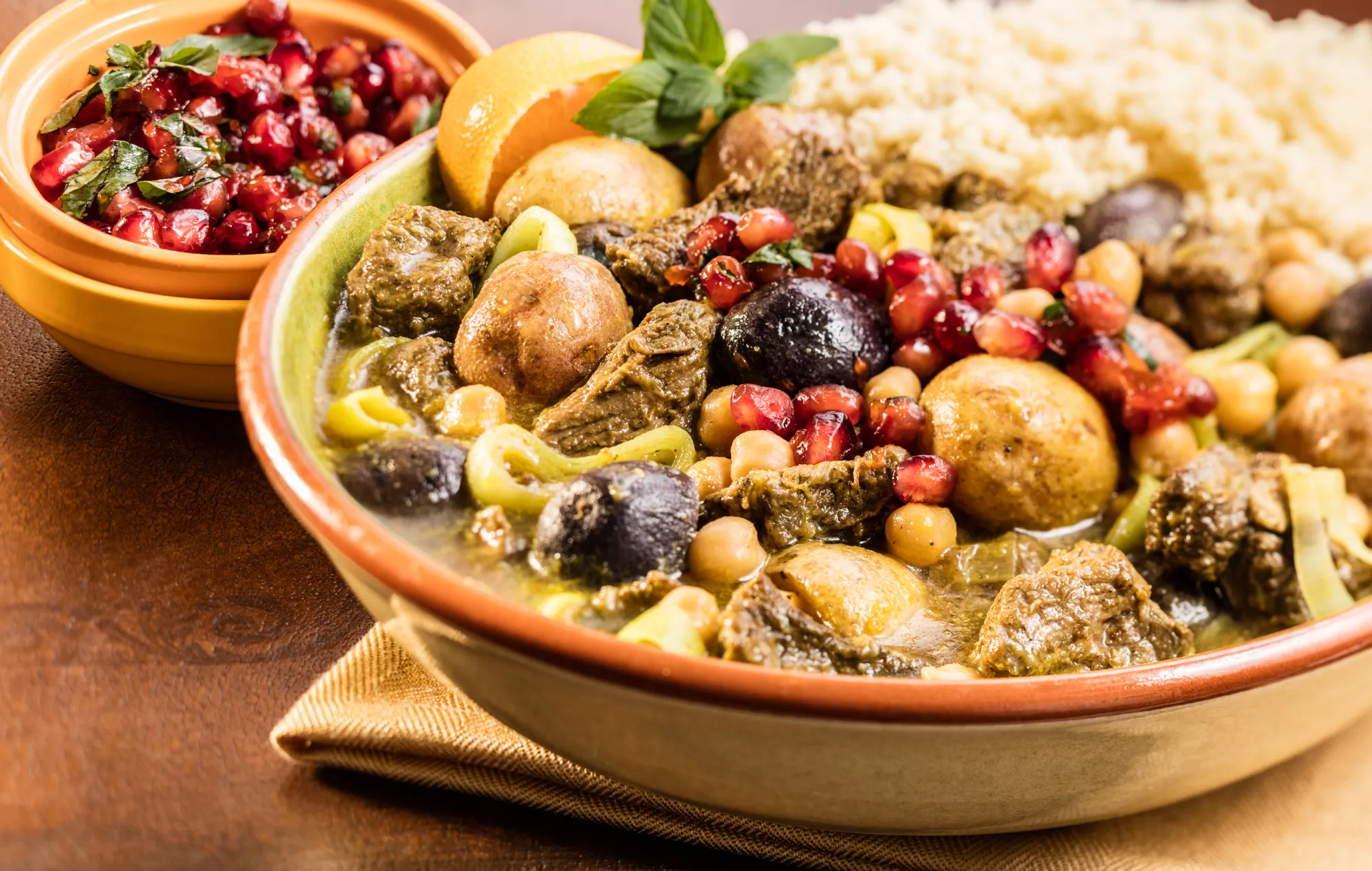 A bowl of stew with lamb and veggies.