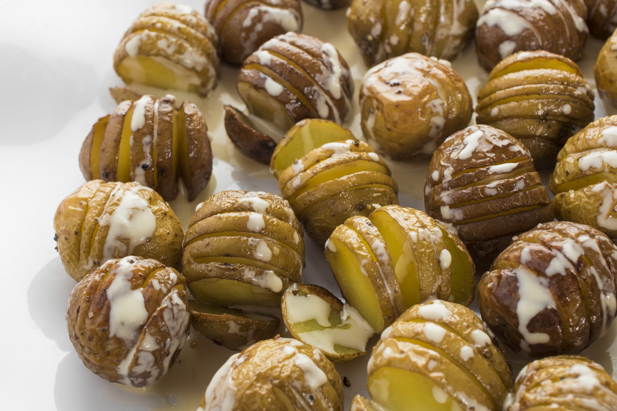 Hasselback potatoes with tahini sauce.
