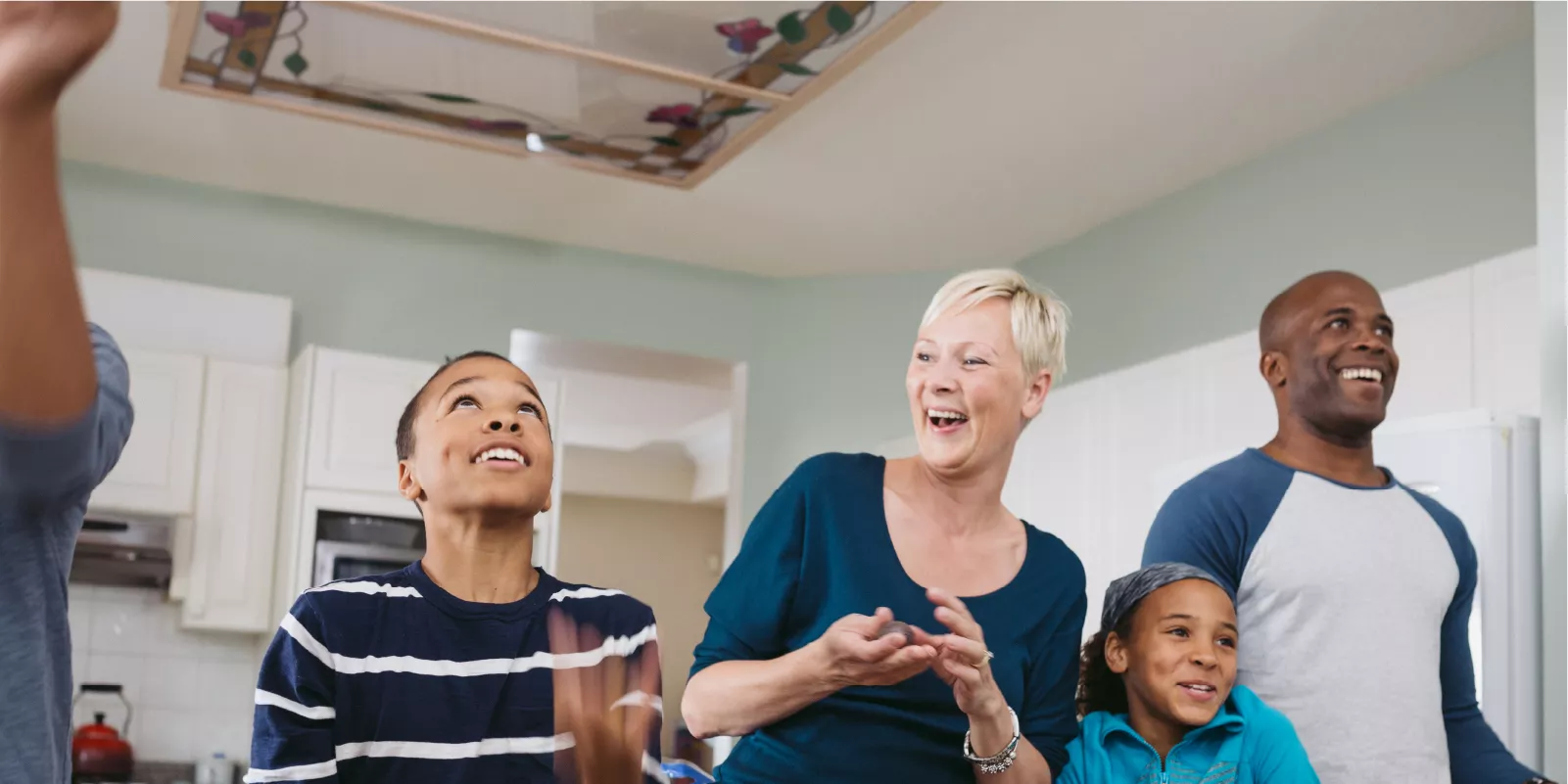 Angela and her family having fun in the kitchen.