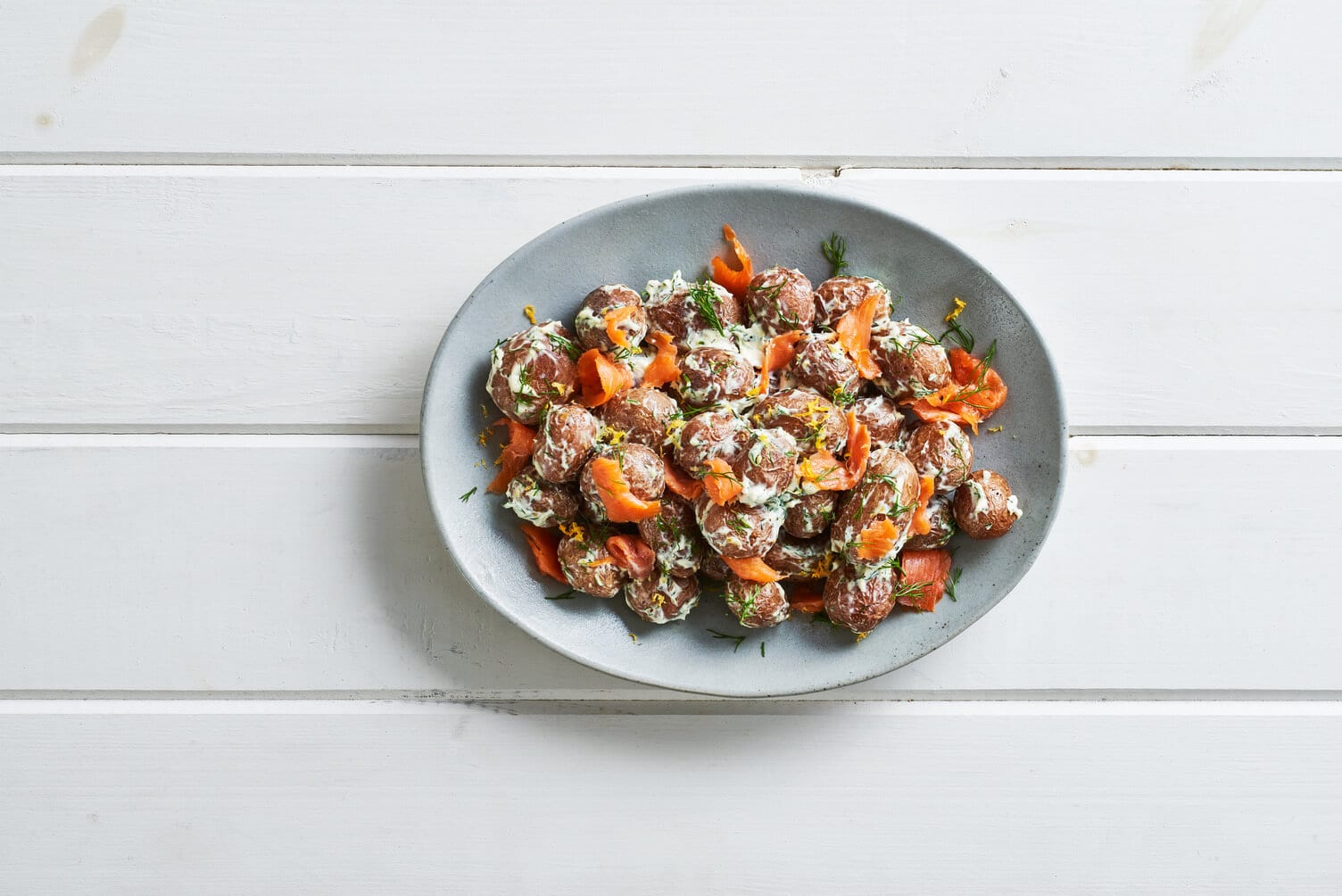 Smoked salmon lox roasted potatoes in a nice little platter.