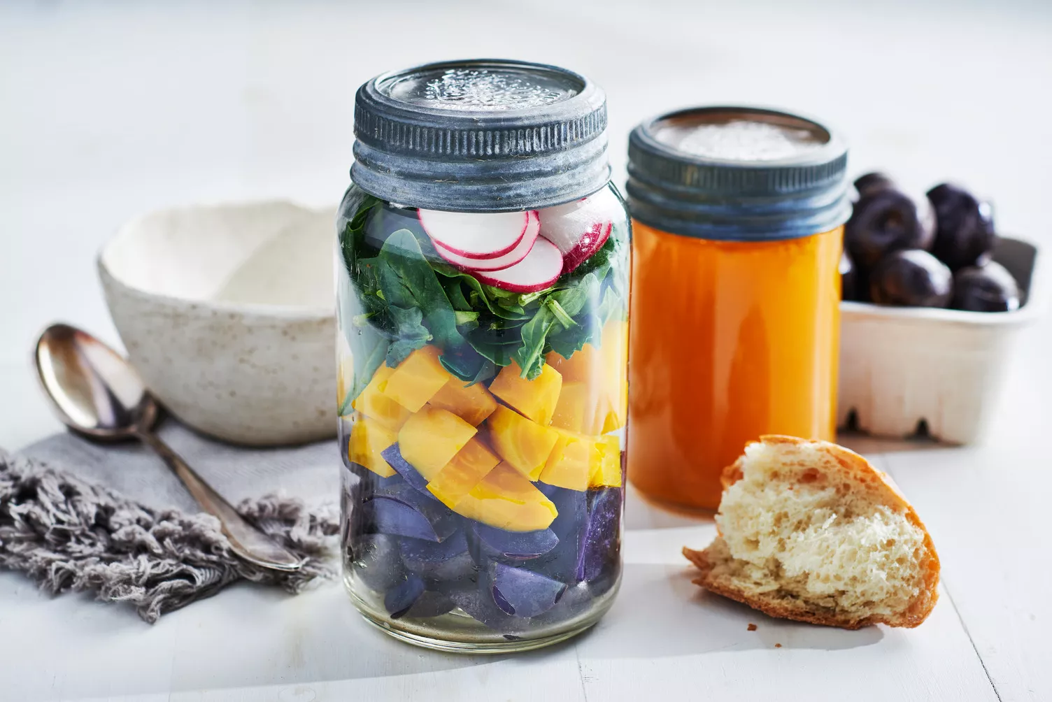 Make-Ahead-Potato-Soup_The-Food-Group_Web-Res-1 Mason jars with stacked colorful veggies ready to make a tasty soup.