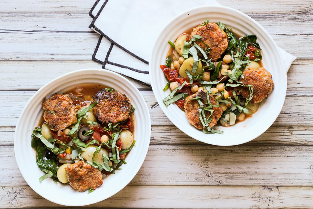 Two bowls of Mediterranean meatball stew.