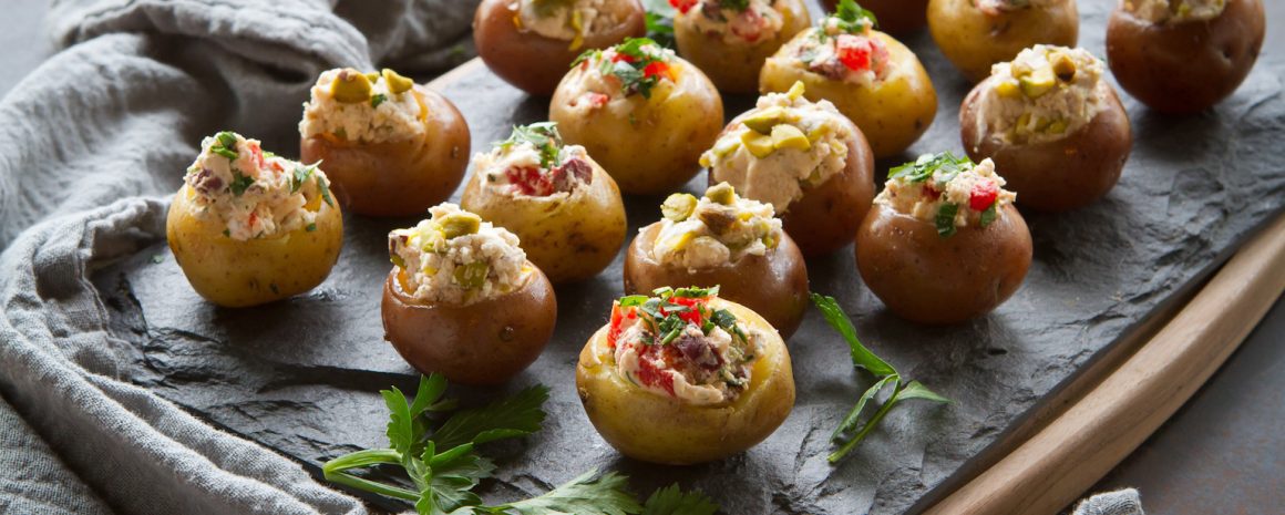 A plate of mini goat cheese stuffed potatoes.