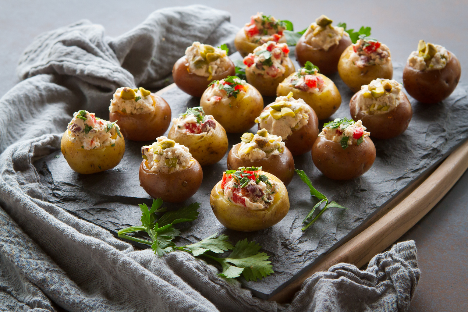 A plate of mini goat cheese stuffed potatoes.