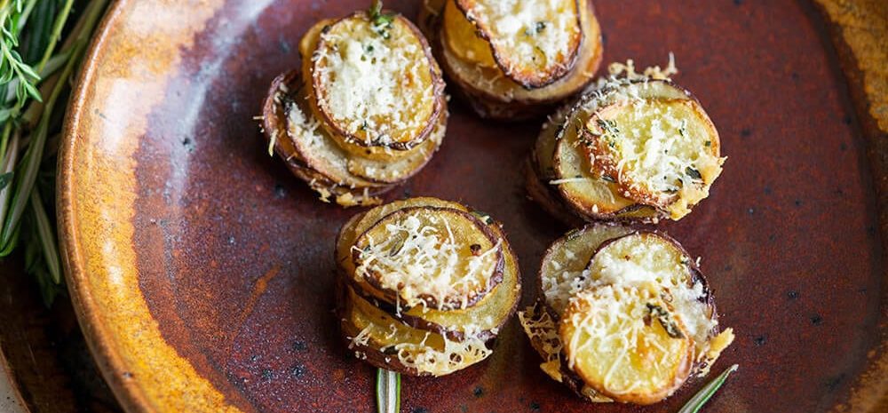 a plate of mini herbed potato stacks.