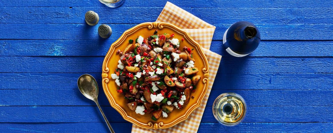 Olive oil and roasted red pepper little potatoes in a nice bowl.