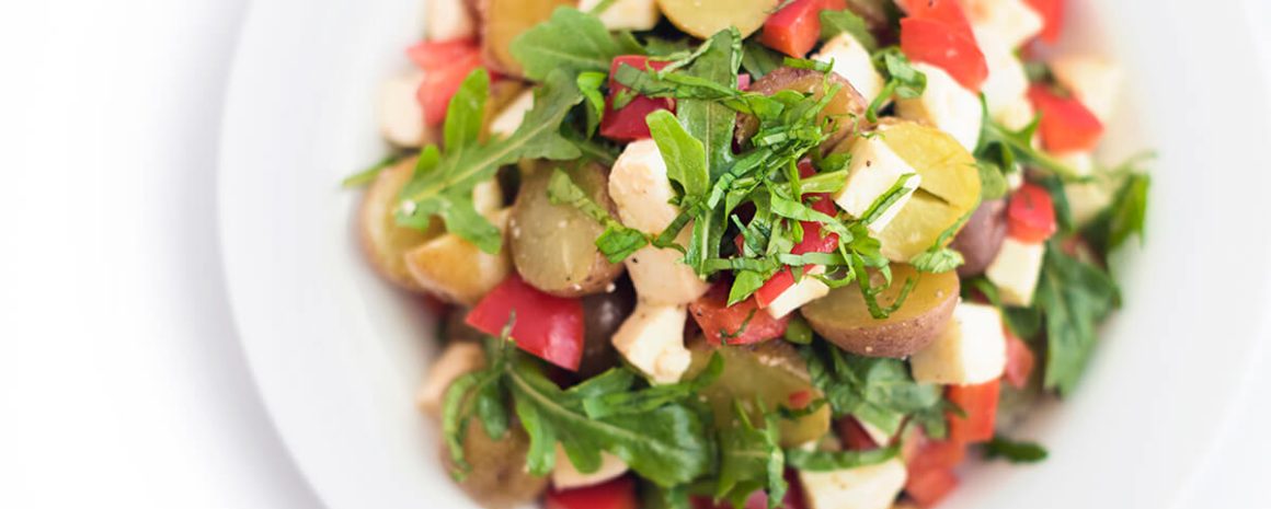 A bowl of potato caprese salad.