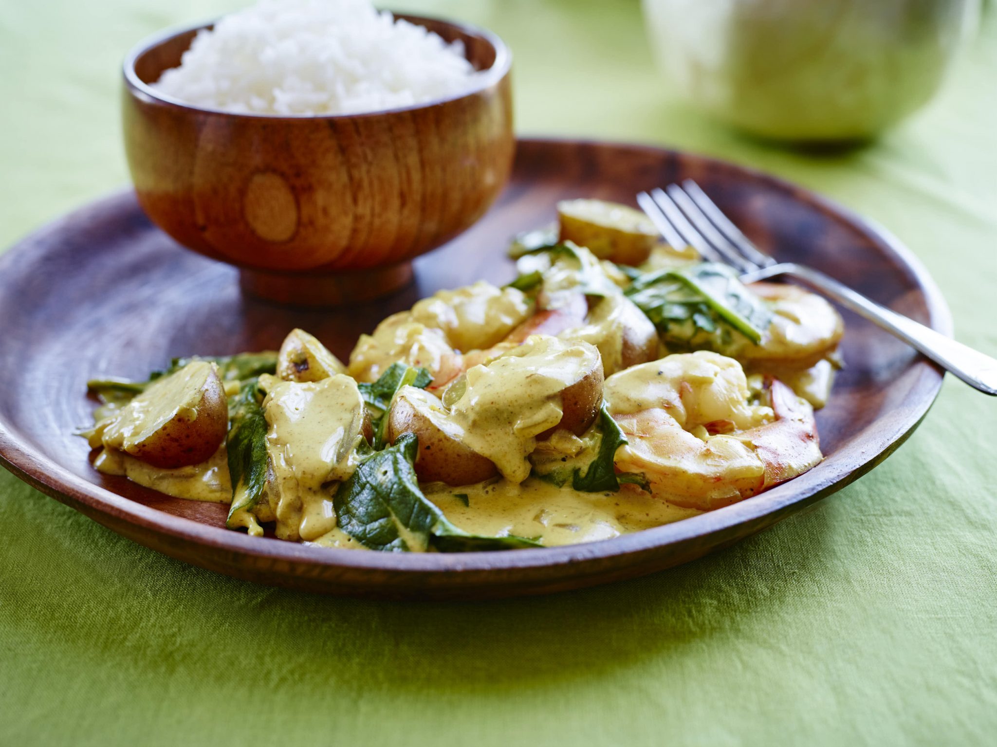 A plate of prawn curry with little potatoes