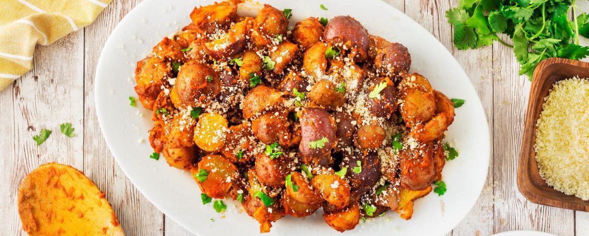 A plate of red pesto little potatoes.