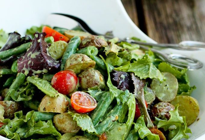 A bowl of roasted potato green bean salad.