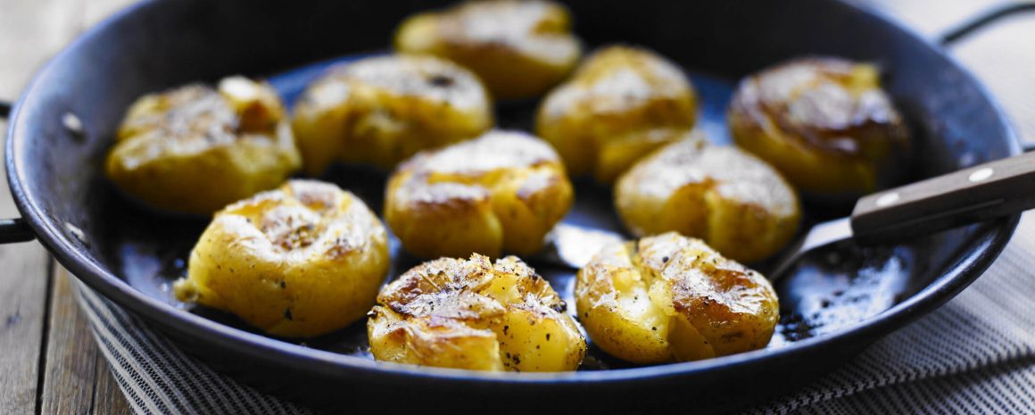 Simply smashing potatoes in a cast-iron skillet.