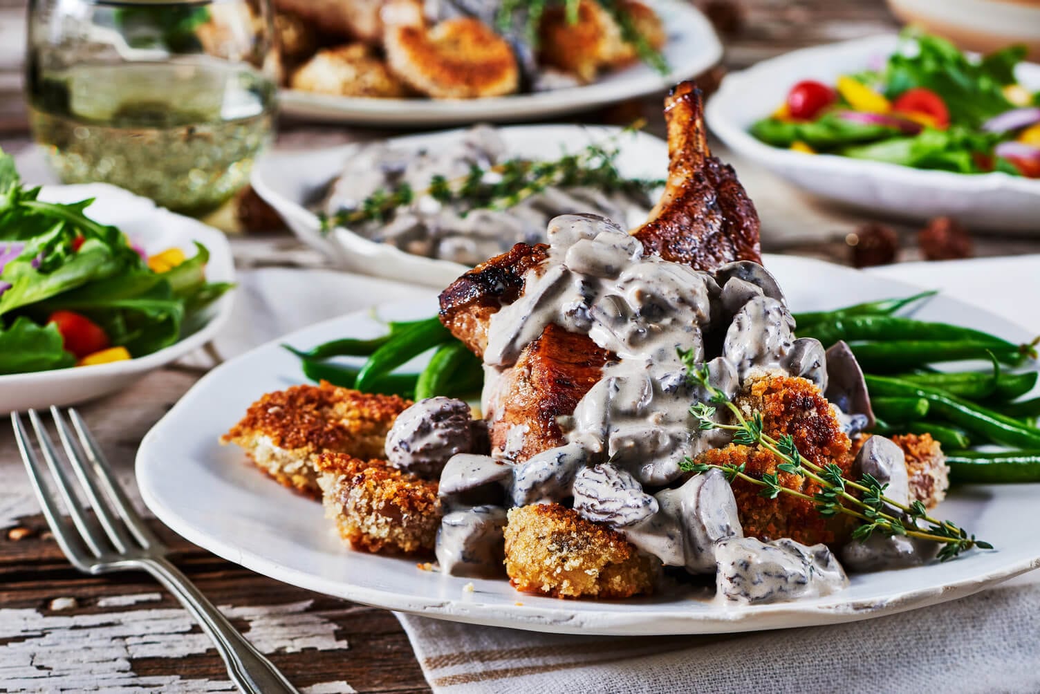 A triumphant pork chop with mushroom gravy and smashed potatoes.