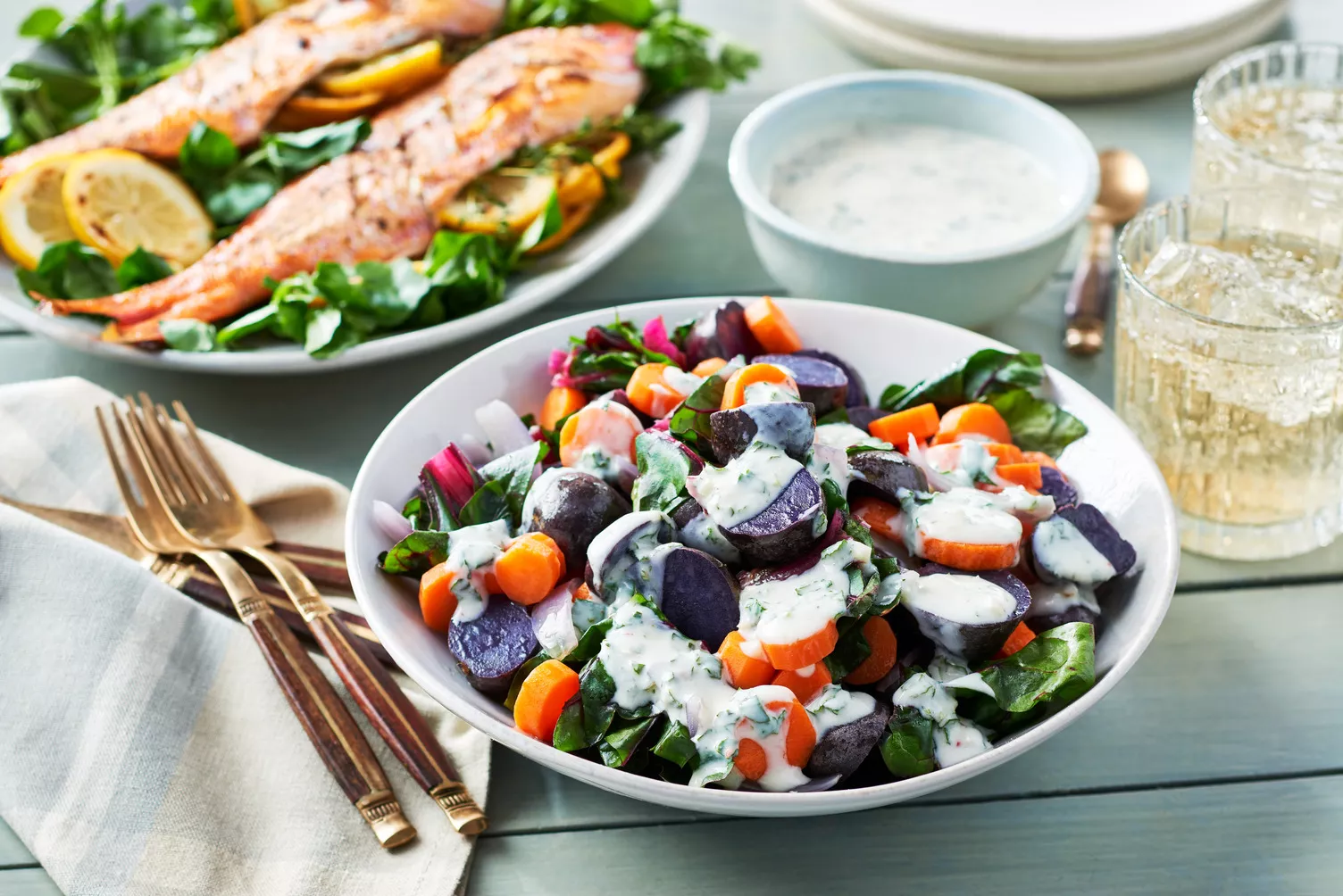 Steamy-Rainbow-Vegetables_The-Food-Group_Web-Res-2 A bowl of steamy vegetables topped with dressing.