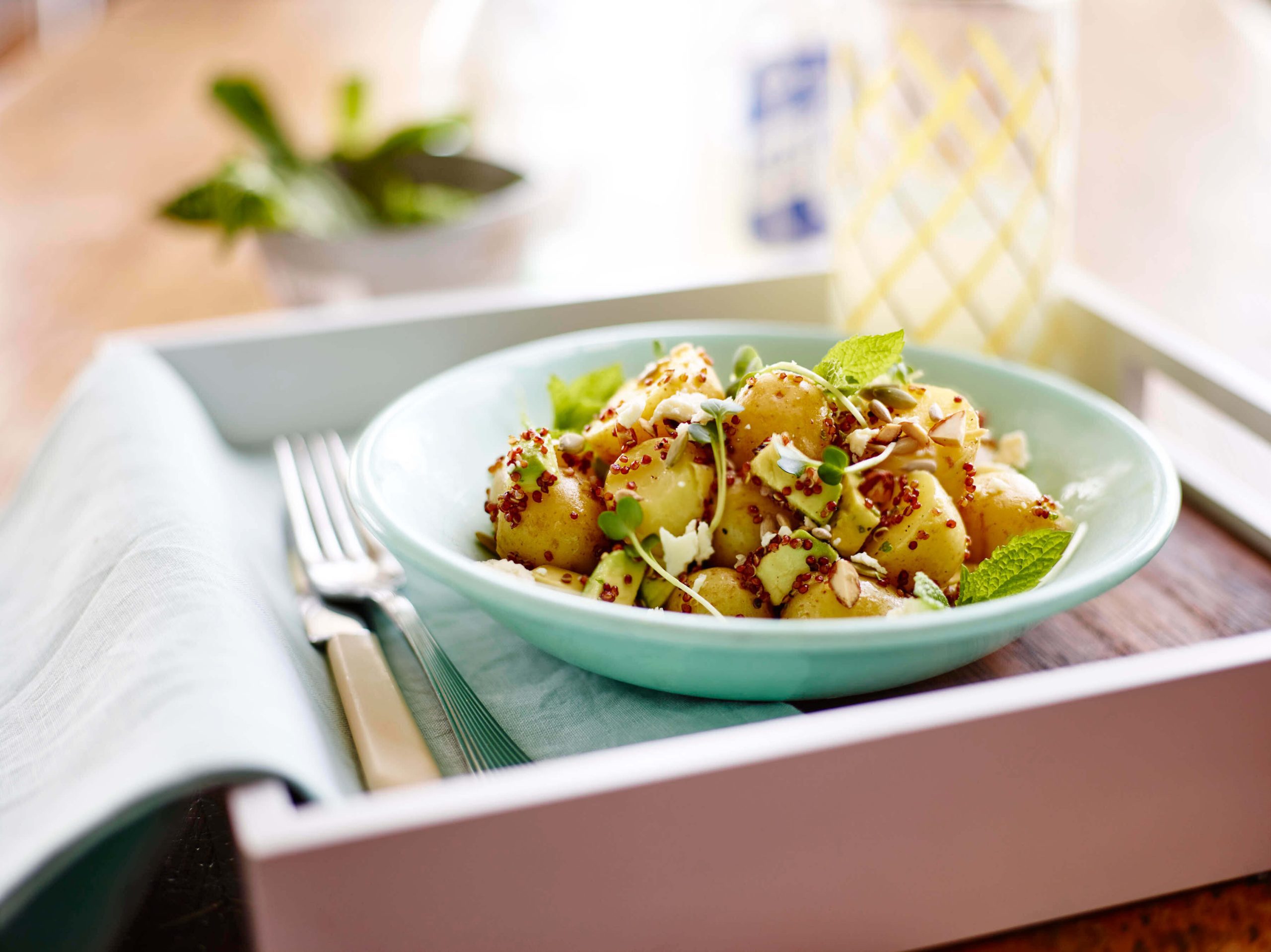 A bowl of Little Potatoes, microgreens, and feta.