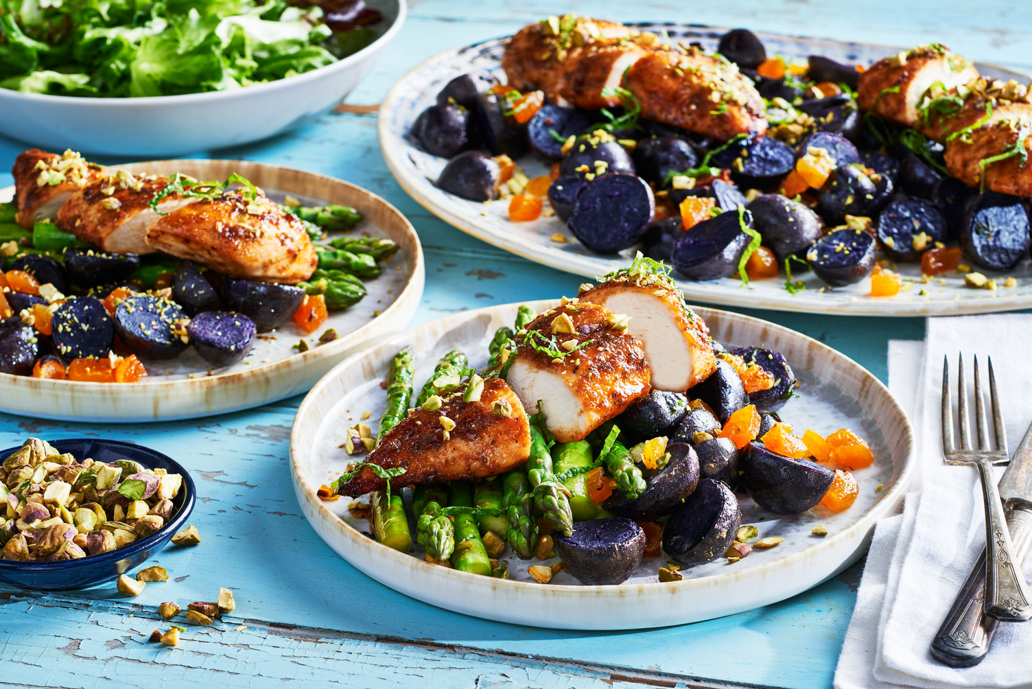 A plate of delicious chicken with Little Purely Purples™, asparagus, and toppings.