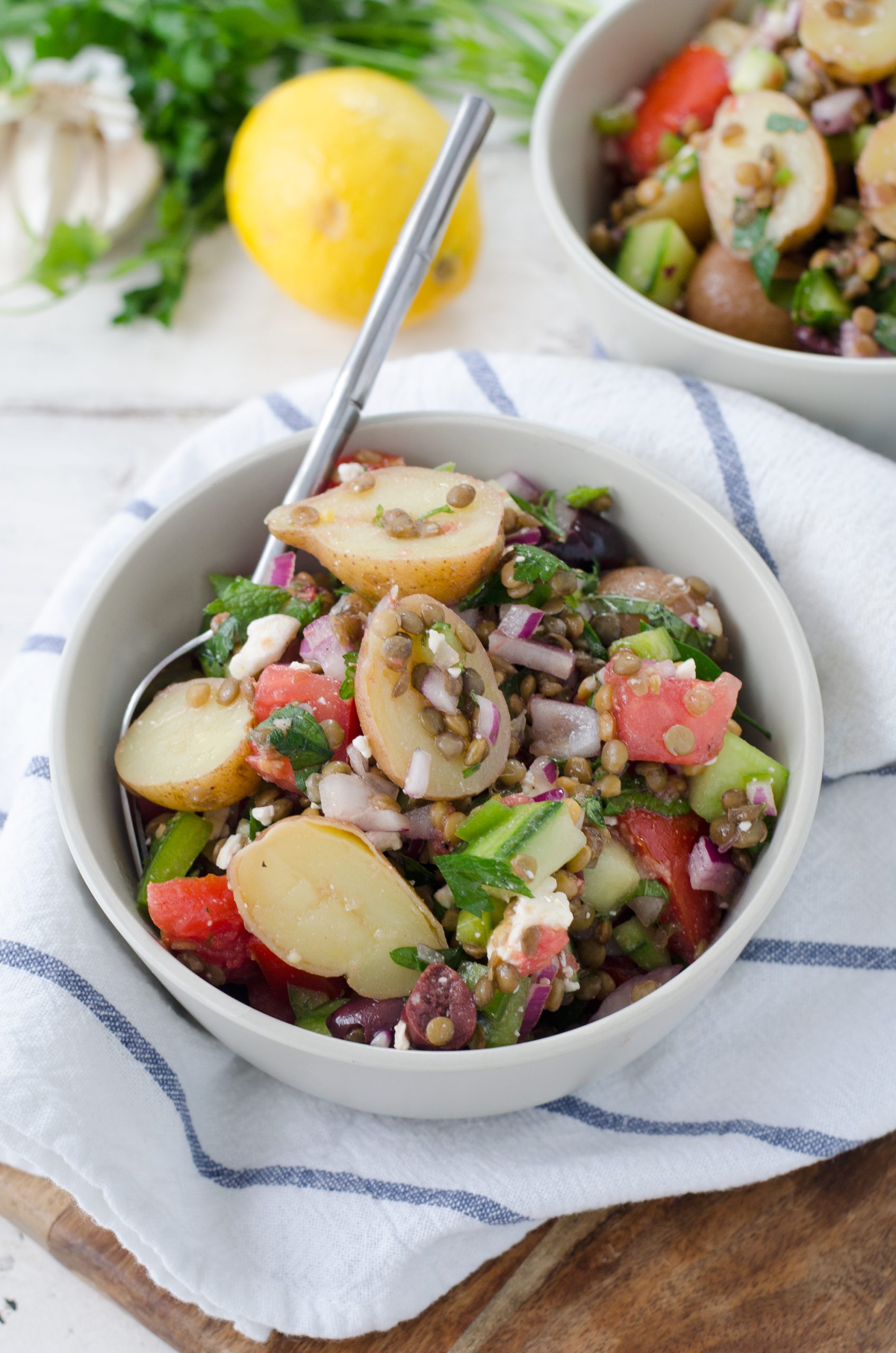 A bowl of Greek salad and lentils.