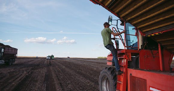 A farmer on a tractor.